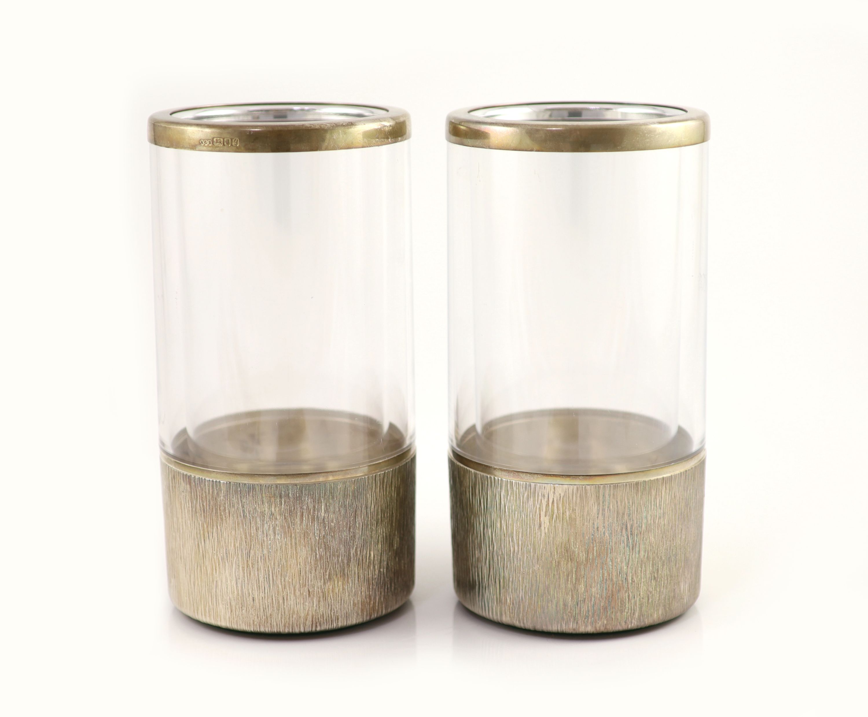 A pair of textured silver bottle coasters by Adrian Gerald Benney, with removeable silver mounted plastic liners